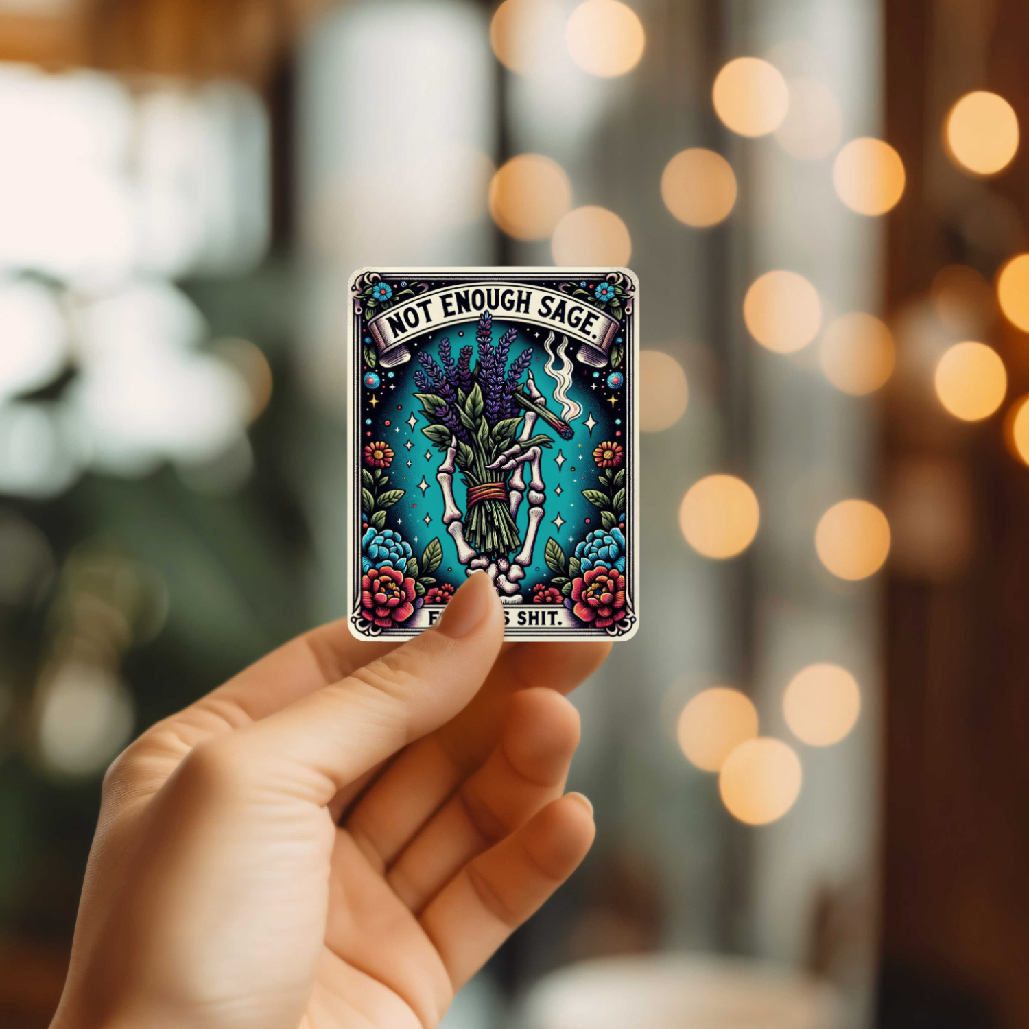 Hand holding a tarot card with &