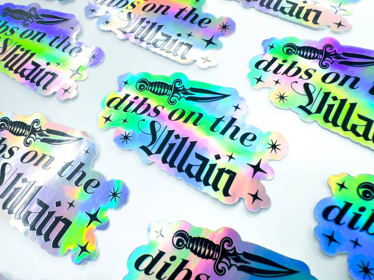 Holographic stickers with text and a sword design on a white background
