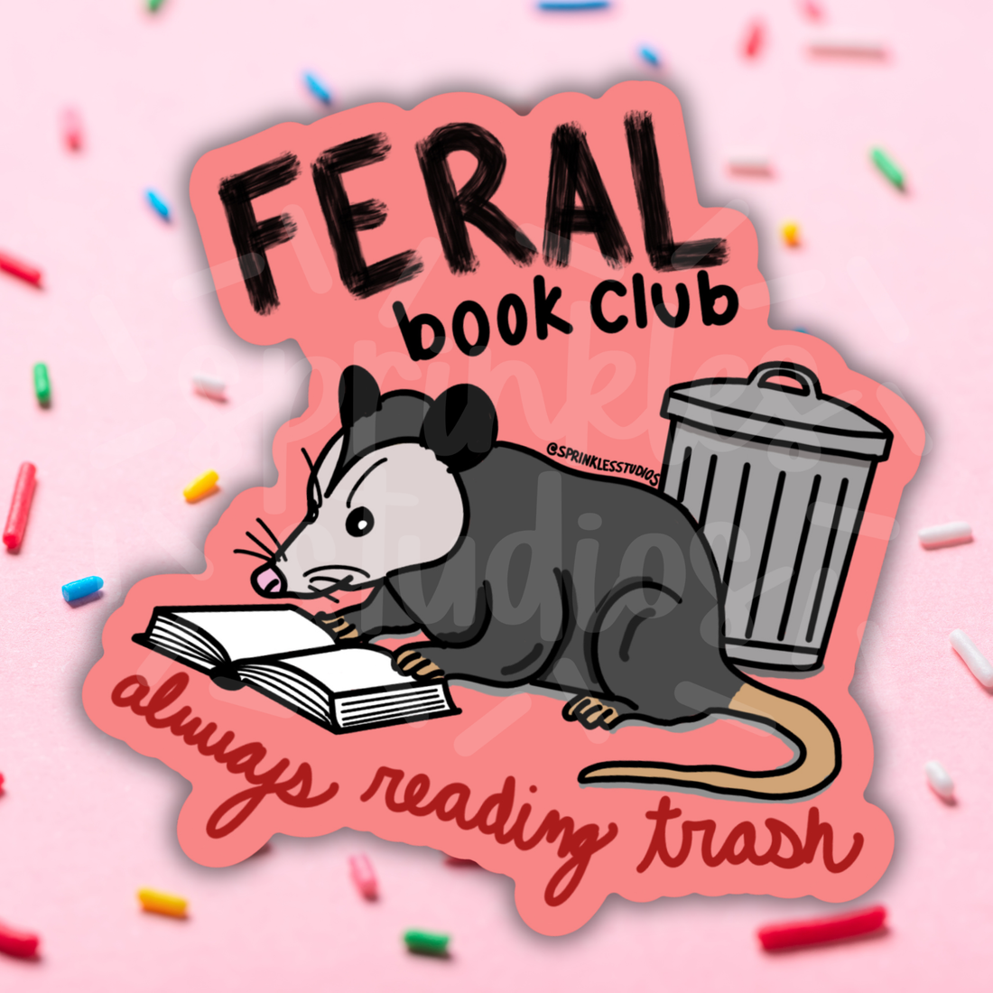 Sticker with a possum reading a book and a trash can, labeled &