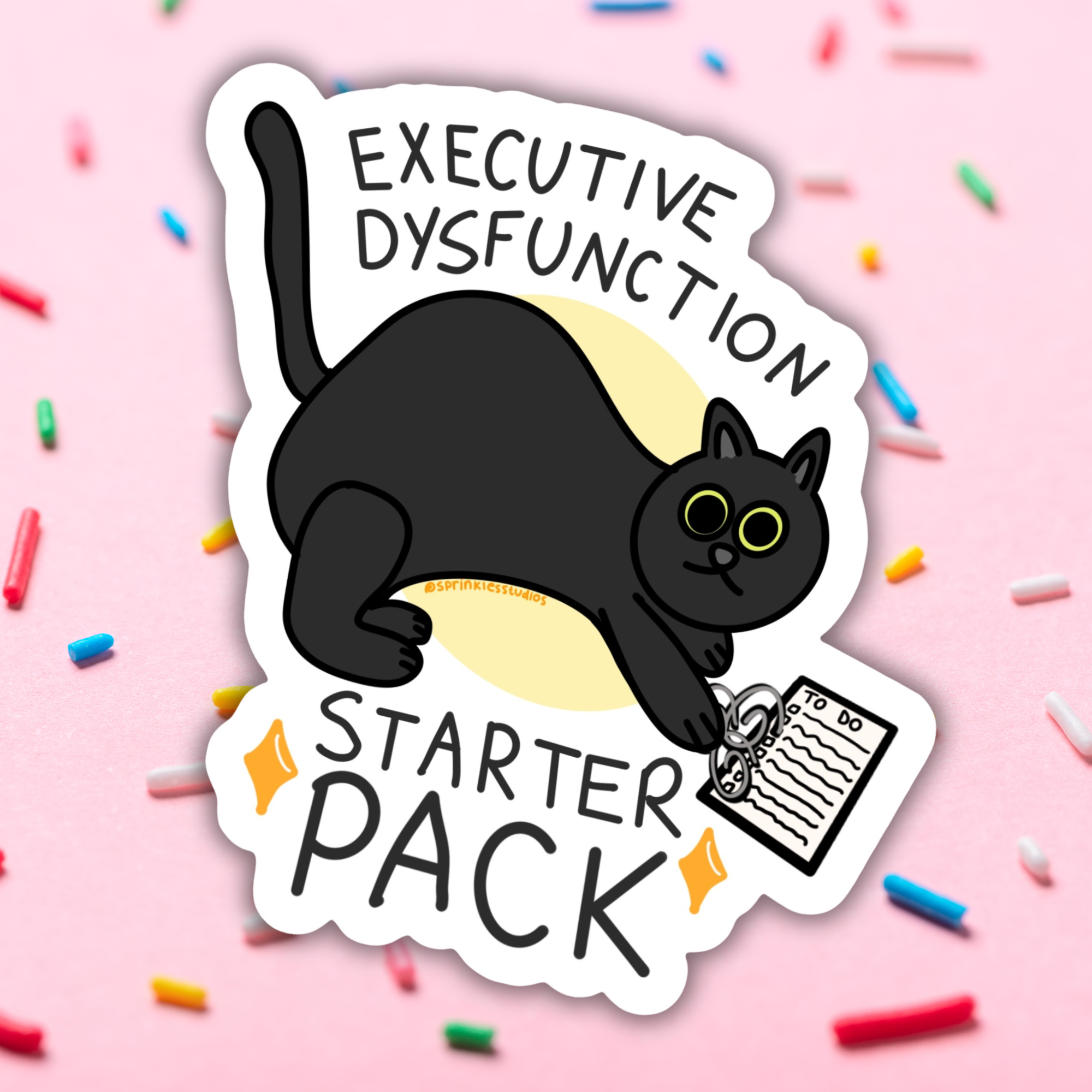 A die-cut sticker featuring a cartoon black cat holding a notepad with the text &