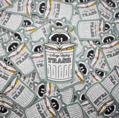 Sticker with a raccoon reading &