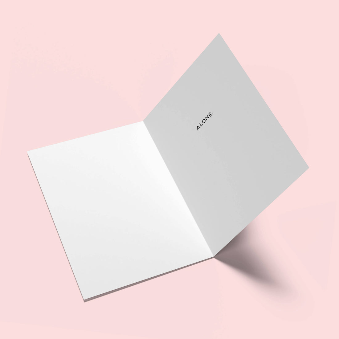 Two greeting cards on a pink background, one open with &
