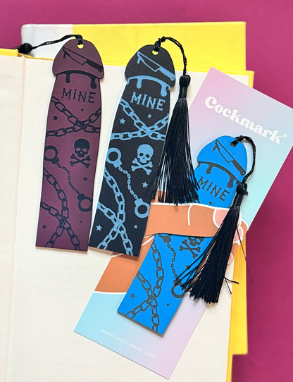 Set of colorful bookmarks with tassels on a pink background