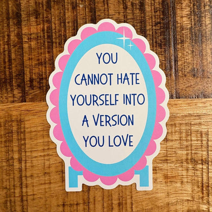 A die-cut sticker with the text &