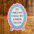 A die-cut sticker with the text &