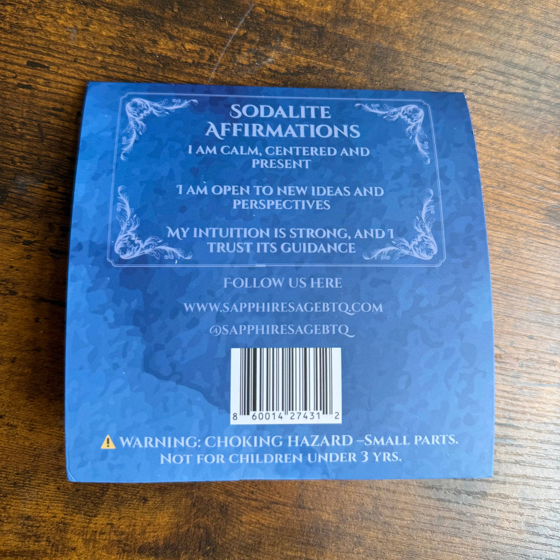 Blue card with affirmations on a wooden surface