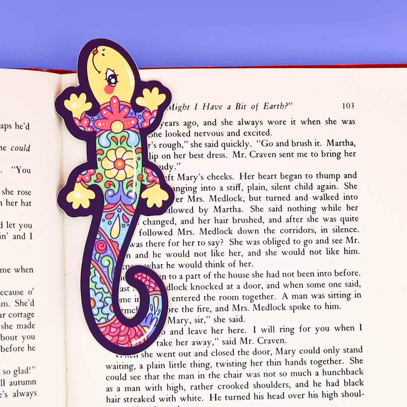 Colorful lizard-shaped bookmark on an open book