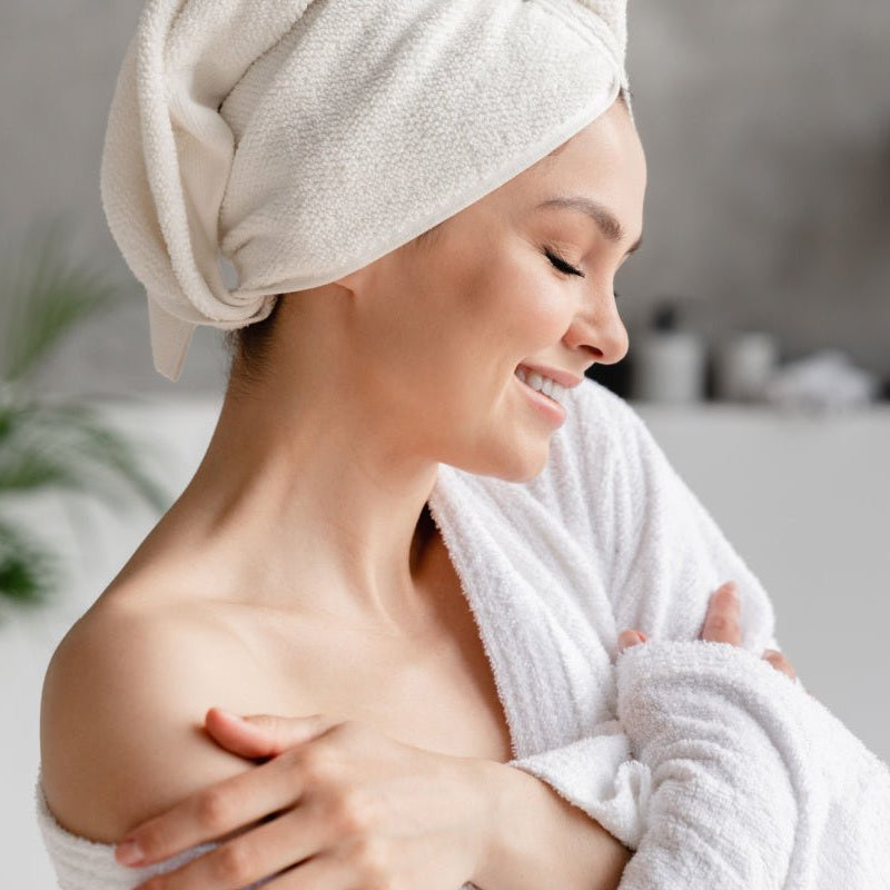 Woman with soft skin after using Elixir Mind Body Botanicals Massage + Body Oils from Elixir Mind Body Boutique