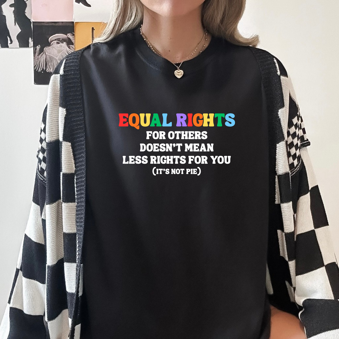 A person wearing a black long-sleeve bodysuit with the text &