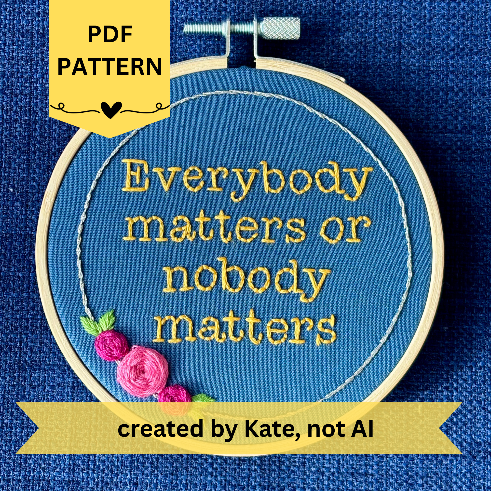 PDF pattern created by Kate, not AI. "Everybody matters or nobody matters." Quote hand embroidered in sunny yellow thread in a serif typewriter font. Framed with a ring of metallic silver thread, spring green leaves, and pink and fuchsia roses. Stitched on blue cotton fabric and displayed in a light wooden embroidery hoop as wall art.