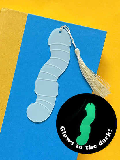 Glowing blue worm-shaped bookmark with tassel on a yellow background