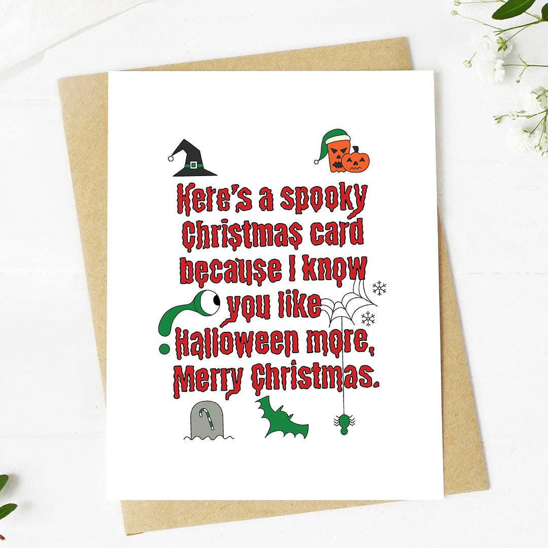 A white Christmas greeting card with red text reading &