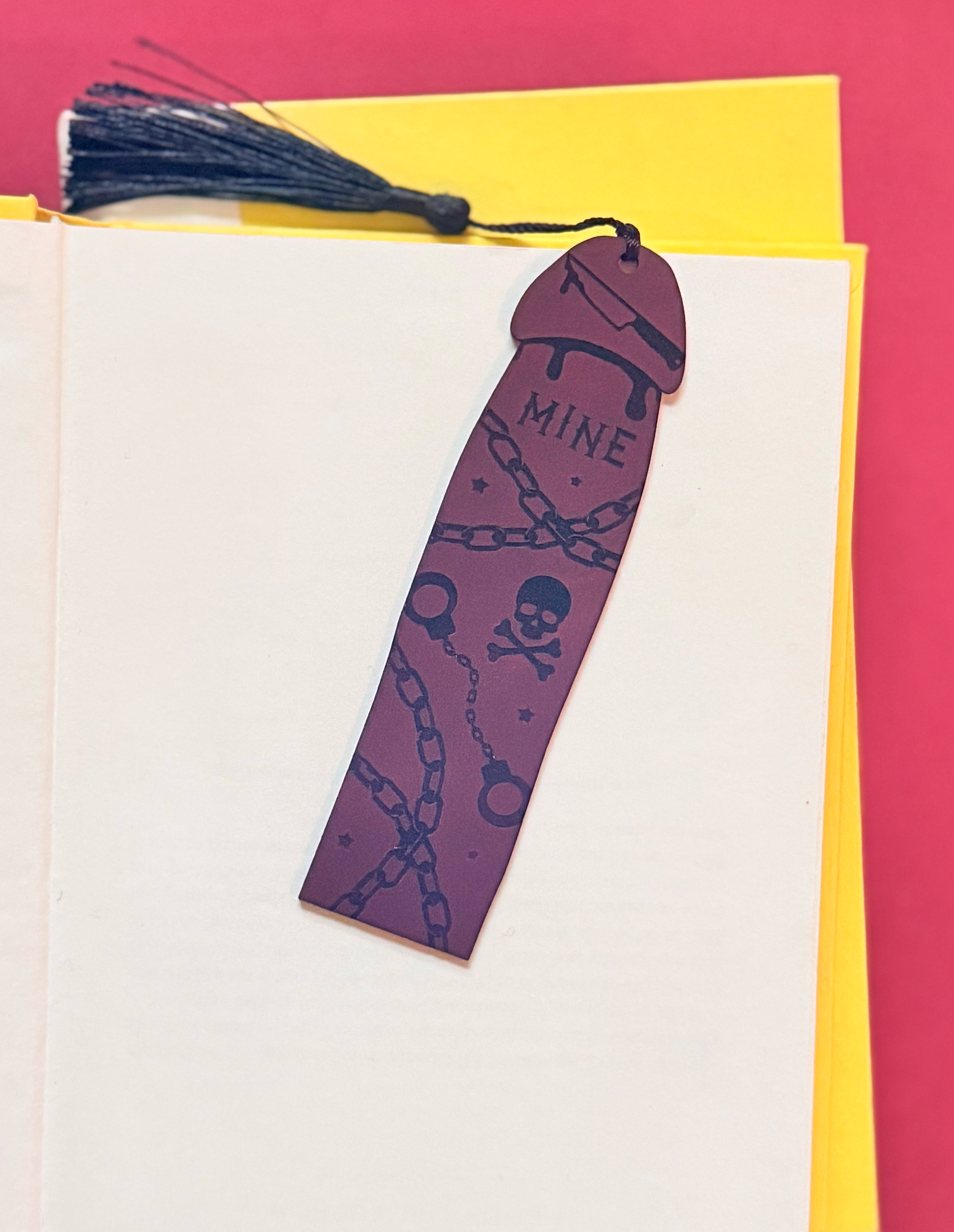 Bookmark with tattoo design on a yellow and red background