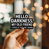 Hand holding a sign with text &