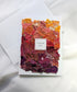 Orange and red fabric collage on a 5 by 7 blank white card with "thank you" handwritten on the front.