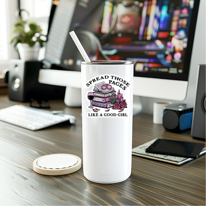 White tumbler with a design and text on a desk with a computer in the background