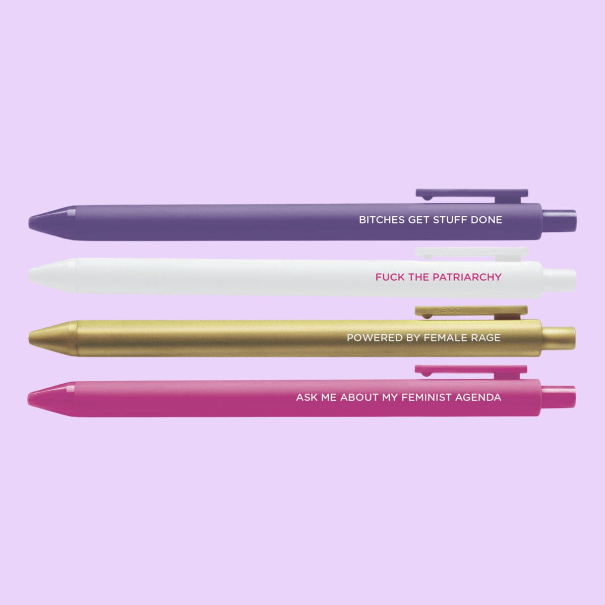 Feminist Agenda Pen Set flat lay — purple and pink jotter gel pens for the desk by indie artist MangoIllustrated