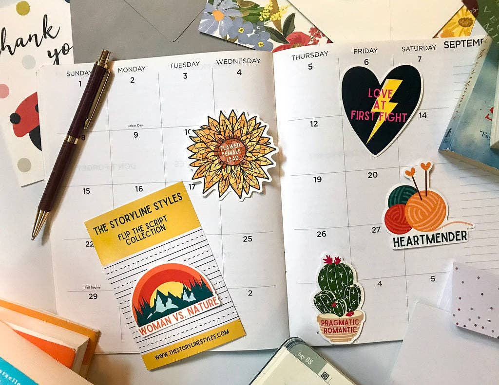 Calendar with stickers on a desk with stationery items
