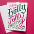 A white Christmas greeting card with festive hand-lettered text reading &