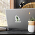 Small Flatwoods Monster cryptid sticker on the back of a silver laptop