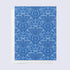 A folded greeting card with a blue background and a white floral Menorah pattern, paired with a bright white envelope.