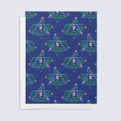A greeting card with a floral design and a Jewish star pattern, with a blank interior and a bright white envelope.