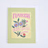 A folded greeting card with a colorful floral design and the words &