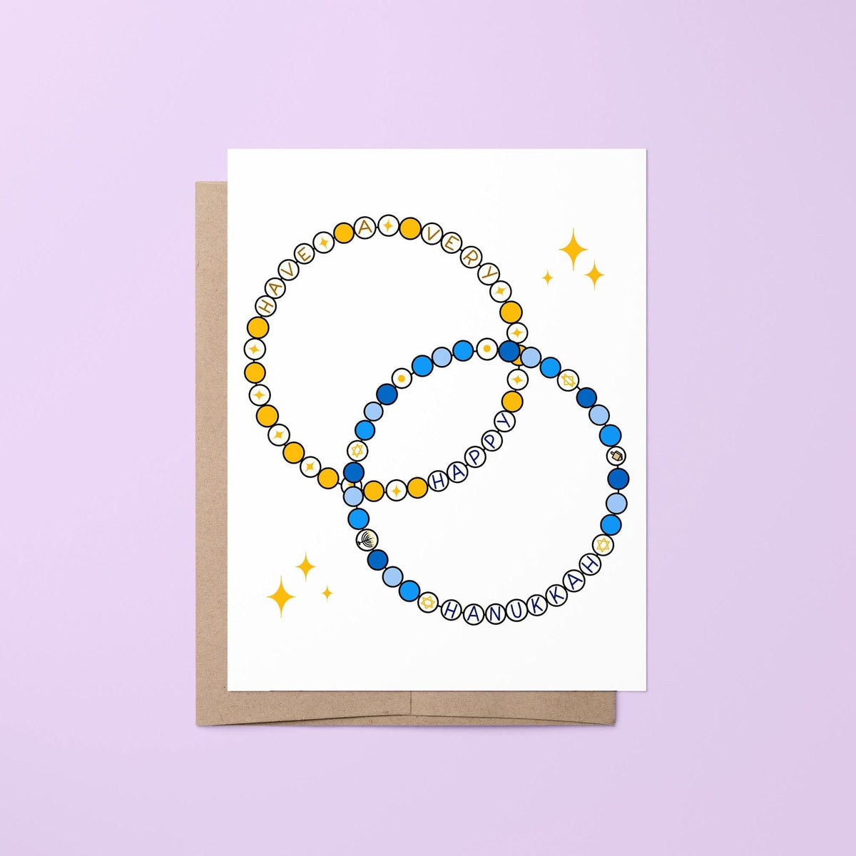 Friendship bracelet Hanukkah card — two illustrated friendship bracelets in gold and shades of blue with hand lettered happy Hanukkah greeting, 4.25 x 5.5 in folded, by MangoIllustrated