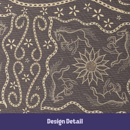 Close-up detail of vintage equestrian embroidered design showing galloping horses, sunburst medallion, and scrolling chain flourishes in cream on dark brown