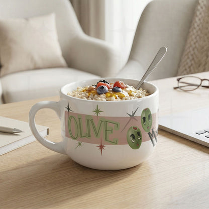 25oz funny mom latte mug filled with oatmeal and berries on a wood desk with notebook and pen, Olive My Kids Are Weird olive pun design visible on white ceramic body