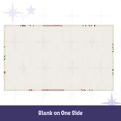 Reverse side of cotton twill tea towel showing blank cream fabric with hemmed edges and partial atomic starburst design visible at borders