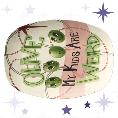 Funny retro serving platter with mid-century modern olive illustration reading Olive My Kids Are Weird, featuring four anthropomorphic green olive characters with expressive lashed eyes on a cream and dusty rose ground with atomic starburst motif