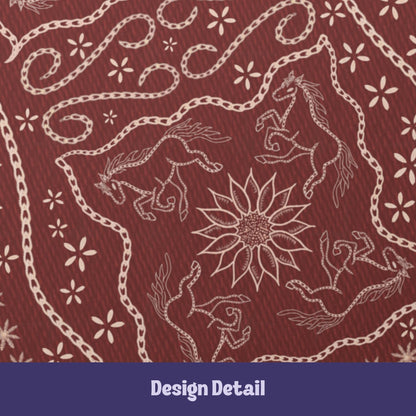 Design detail showing four galloping horses arranged around a sunflower starburst in stitched folk art style on burgundy journal cover