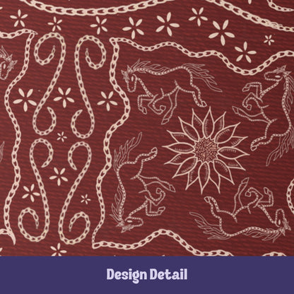 Close-up detail of stitched leather effect folk art illustration showing galloping horses, sunflower medallion, and chain-stitch rope scrollwork on burgundy journal cover