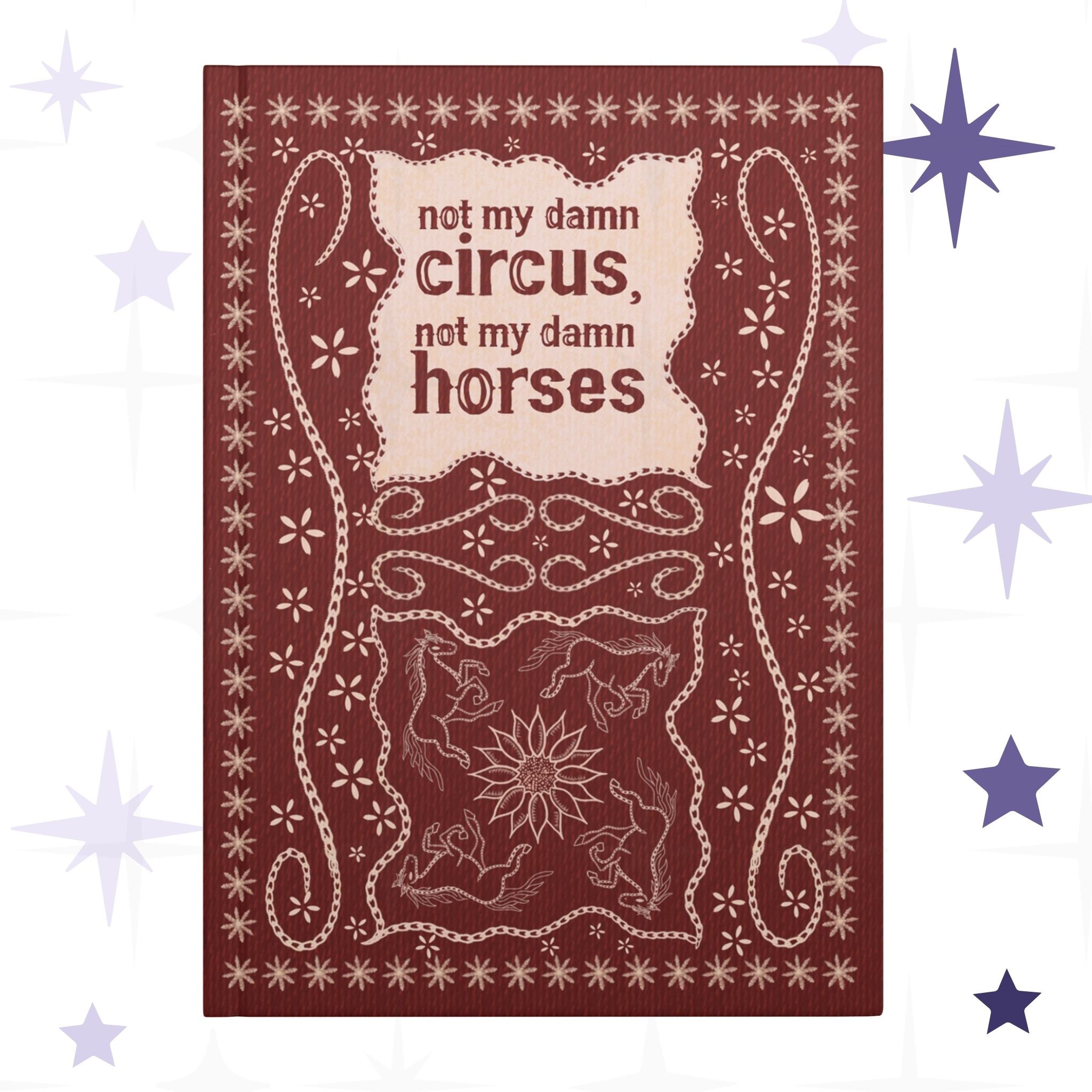 Funny western hardcover journal with hand-lettered text reading not my damn circus not my damn horses in stitched leather effect on deep burgundy cover with folk art horses and sunflower