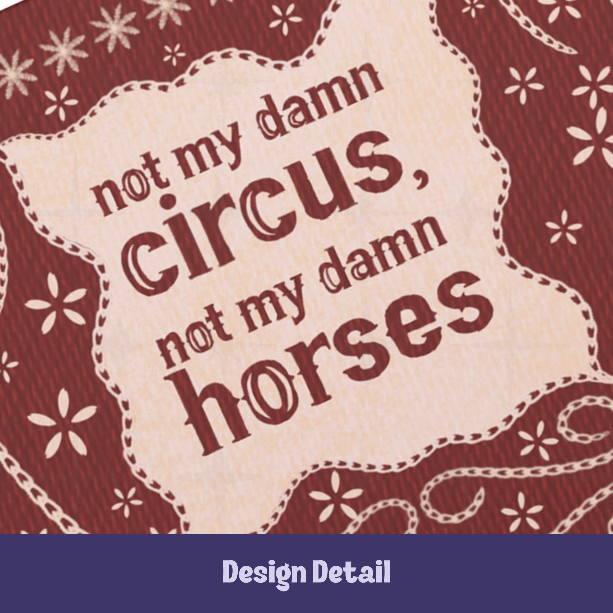 Close-up detail of hand-lettered text reading not my damn circus not my damn horses on cream cartouche with stitched border on burgundy cover
