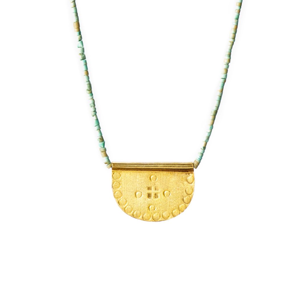 Ethically made by hand, 10k Gold vermeil necklace with a textured, hand-stamped pendant with green turquoise beads, flat lay