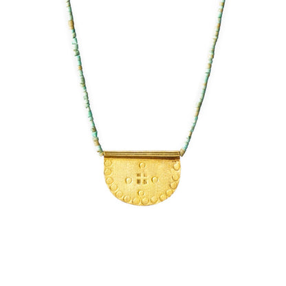 Ethically made by hand, 10k Gold vermeil necklace with a textured, hand-stamped pendant with green turquoise beads, flat lay