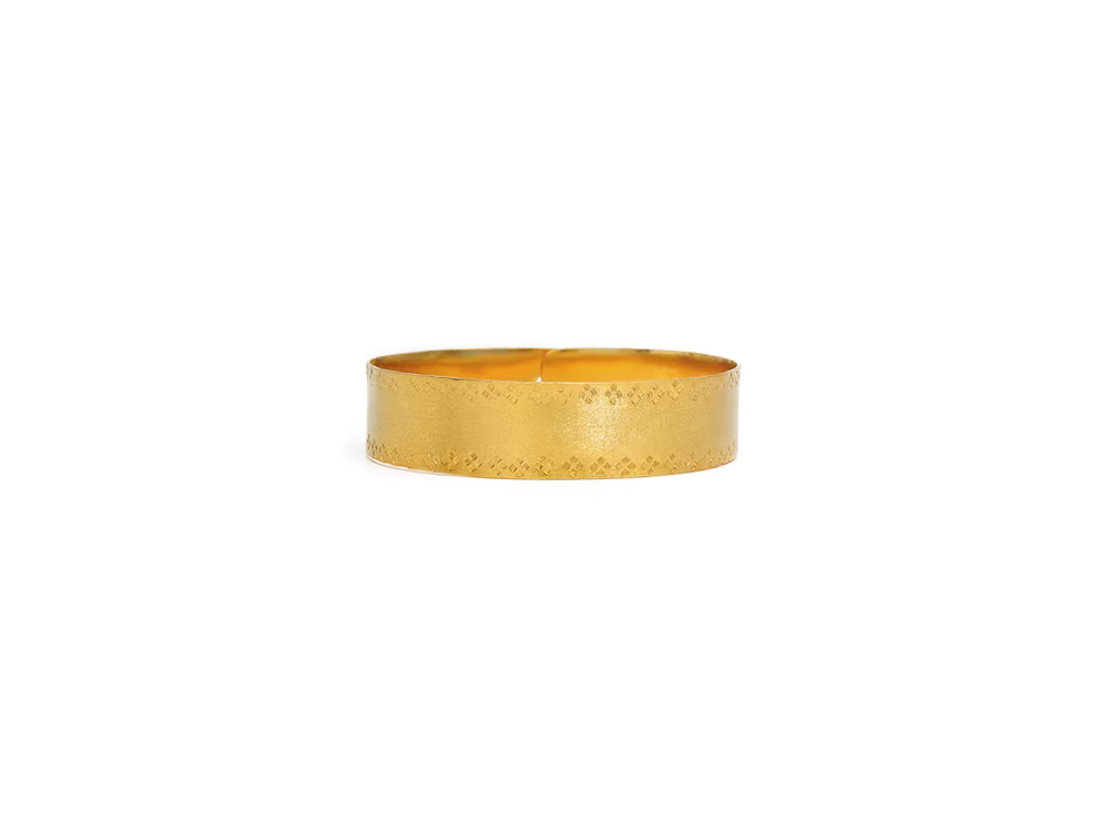 A handcrafted gold vermeil bracelet featuring a matte textured finish and diamond shaped handstamped edges, with a pin closure, flat lay