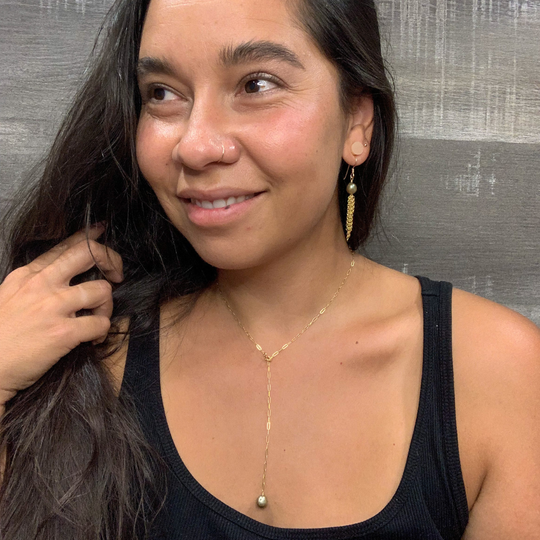 green pearl and gold chain lariat necklace on a model