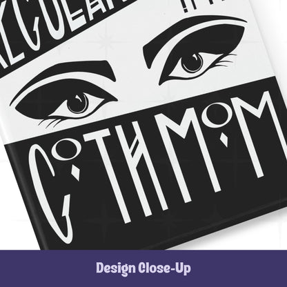 Close-up of bottom section of goth mom magnet showing dramatic illustrated eyes with heavy brows and lashes above Goth Mom lettering on black