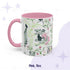 Pink 11 oz preppy gothic toile mug with a green-skinned woman rolling out a brain and a cat