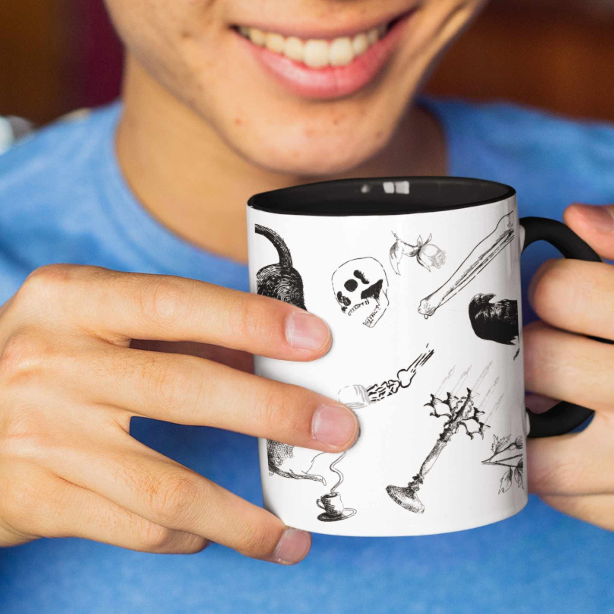 Person smiling while holding a black and white gothic zombie icons pattern mug with black handle
