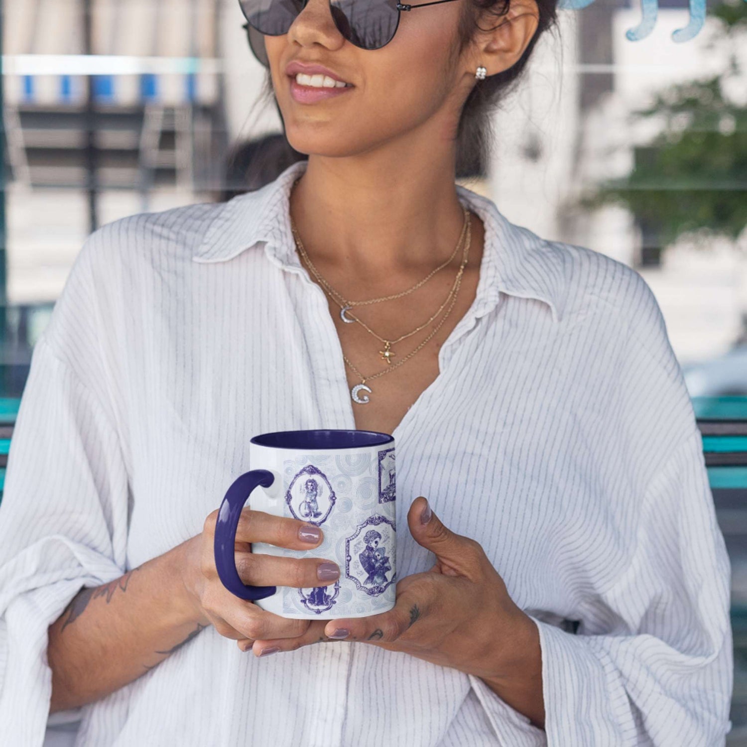 Person holding a blue and white delft zombie portrait gallery mug with navy handle