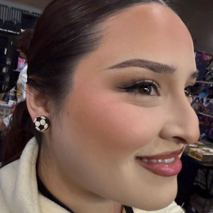 Close-up lifestyle photo showcasing the lightweight fit and everyday size of the hand-painted wooden soccer ball stud earrings. Worn with casual attire to highlight their sporty style and comfortable all-day wear.