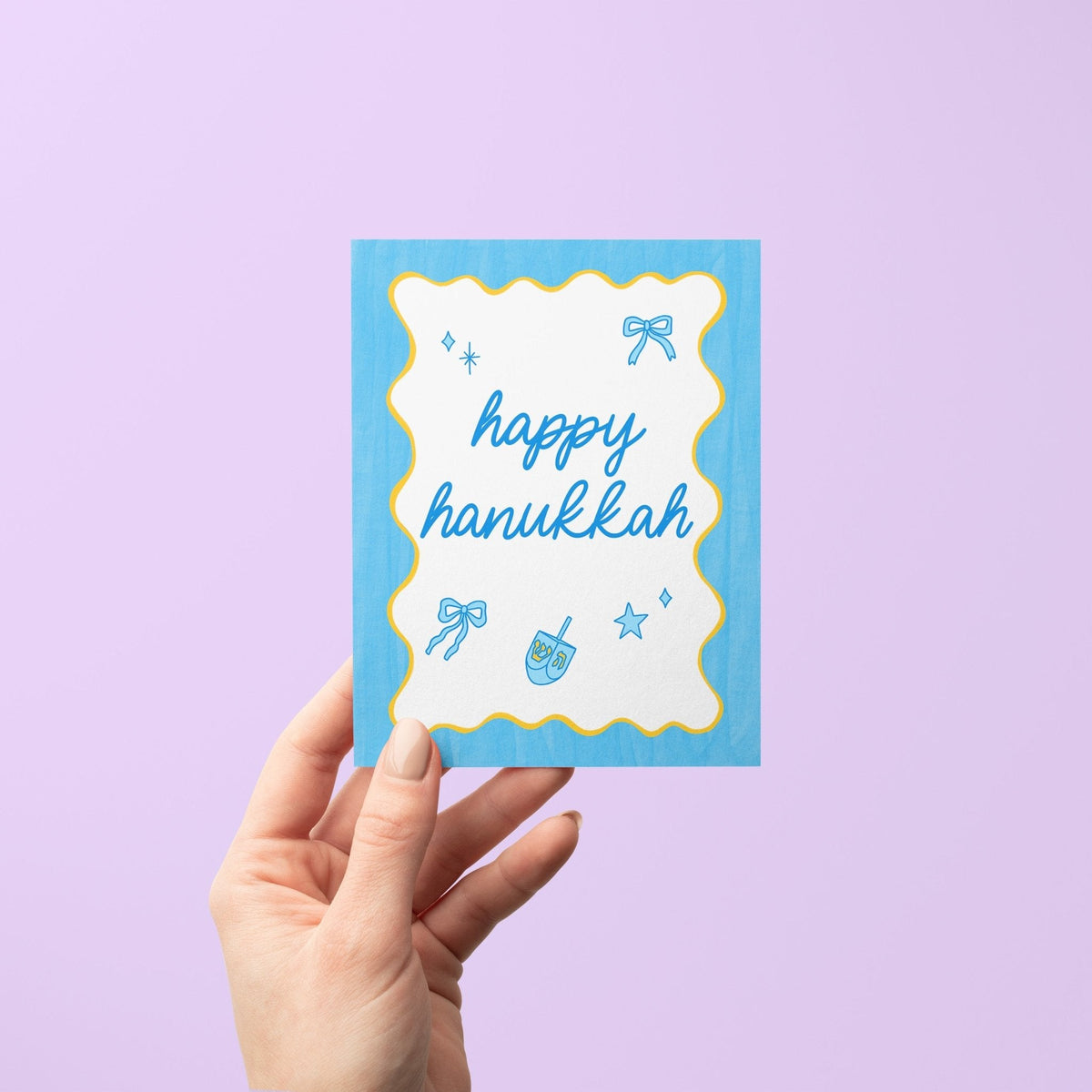 Happy Hanukkah Greeting Card with A2 kraft envelope — cute Jewish holiday card with dreidels and bows by indie artist MangoIllustrated