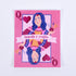 A pink sticker with a design of a queen playing card surrounded by hearts and crafting tools. The text &