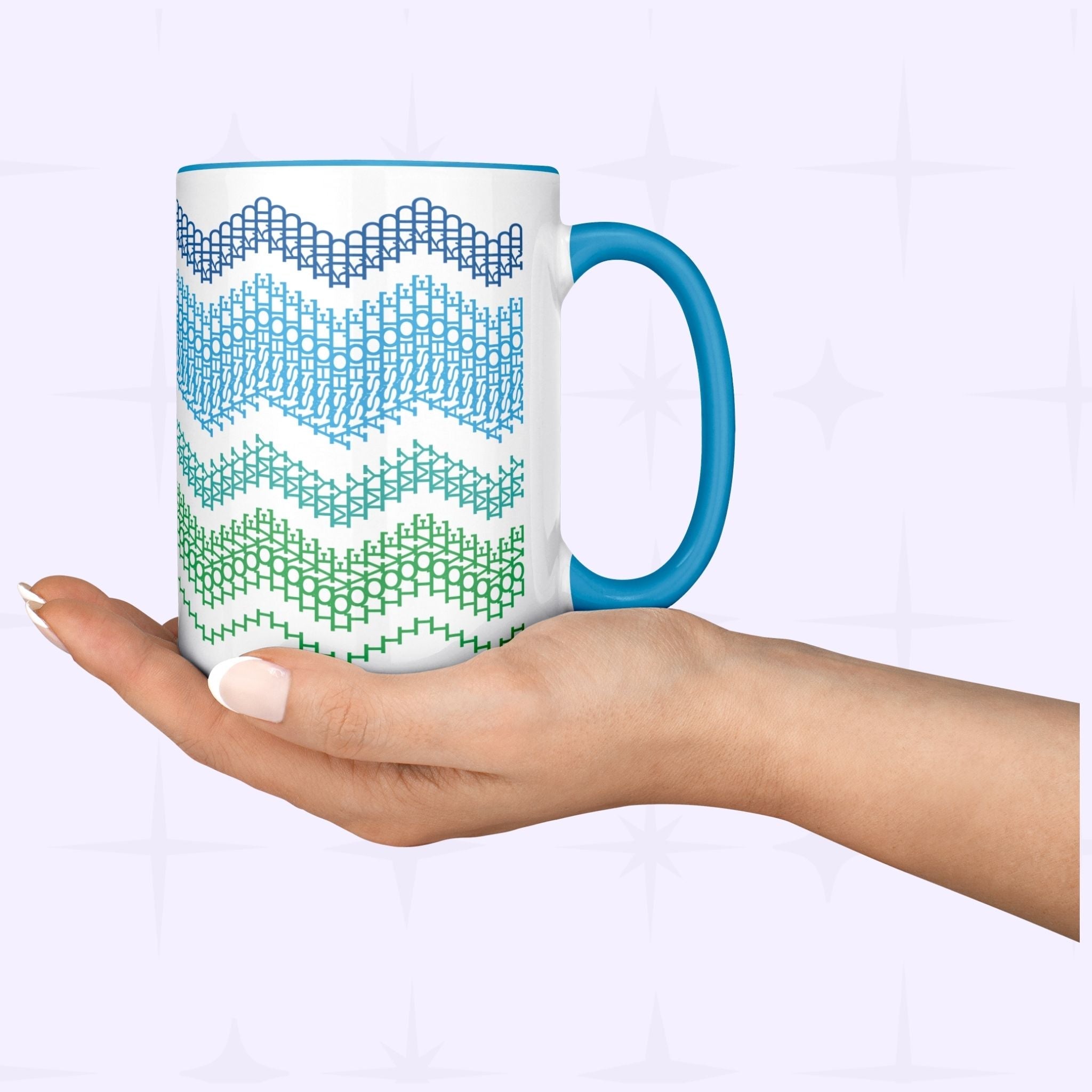 Lifestyle shot of a hand holding the Ocean Blue 15oz hidden message mug from below, showing the full-wrap chevron pattern against a soft lavender background