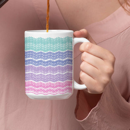 Woman holding bright stripes hidden message mug while wearing a pink shirt