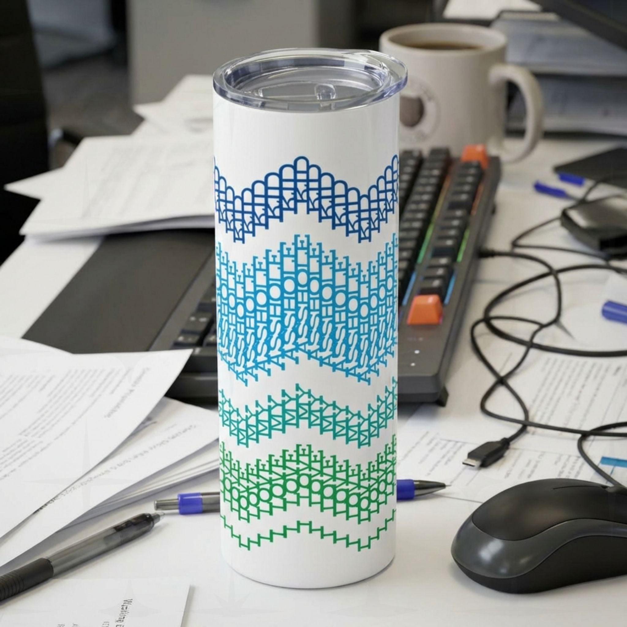 Ocean Stripes I Love My Asshole Kid 20oz tumbler standing on an office desk surrounded by papers and keyboard — navy to forest green gradient typographic band pattern